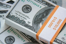 Stack of $10,000 with scattered bills Bundle of $10,000 in U.S. 100 dollar bills with other scattered bills