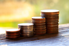 Coin stacks morning light Stacks of pennies, nickels, dimes, and quarters in morning light