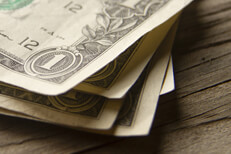Stack of random dollar bills Random stack of dollar bills on wood background