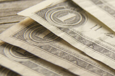 Close up free photo of dollar bills fanned out on wood background