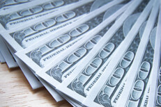 Fanned out $100 bills close view $100 bills evenly fanned out on wood table close up photo