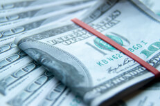 $100 bills folded with fanned bills $100 bills folded with rubber band on fanned out $100 bills