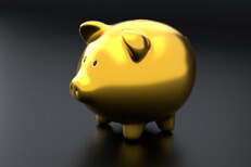 Shiny gold piggy bank on dark background concept for savings, retirement, investments, or wealth