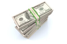 Top view of large stack of $10,000 cash bundles isolated on white