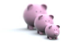 Three pink piggy banks of different sizes representing different investment choices and returns