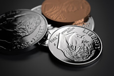 Assortment of U.S. currency coins with focus on dime