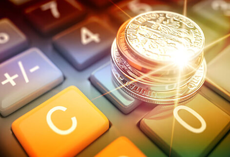 Coins on calculator Stack of U.S. coins on calculator with lighting flare and overlay effect