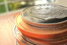 Stack of U.S. coins with window in background