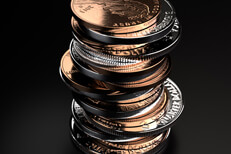 Large vertical stack of shiny U.S. coins on black background
