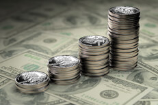 Quarters stacked on bills Increasing stacks of U.S. quarters stacked on one hundred dollar bills