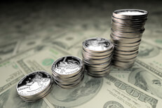 Increasing stacks of U.S. quarters on Benjamins with 24mm lens