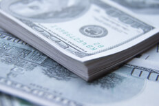 Stack of money Orderly stack of $100 bills on top of other scattered $100 bills