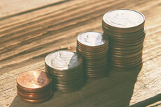 Vintage U.S. coin stacks Stacks of pennies, nickels, dimes, and quarters on wood planks with soft vintage filter