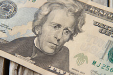Single twenty dollar bill on wood Single twenty dollar bill showing President Jackson on wood background