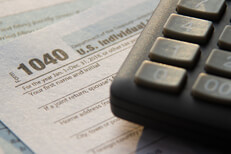 Sunrise lighting tax 1040 form with corner of calculator