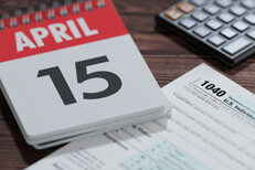 April 15th tax calculator Day calendar showing April 15th with IRS tax form 1040 and calculator