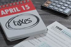 April 15 tax reminder Spiral day calendar for April 15 showing word taxes circled