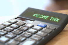 Tax concept image of a calculator with LCD reading Income Tax