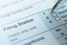 Tax filing status Photo of 1040 tax form filing status with ballpoint pen on Single option