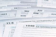 Photo of many tax forms concept demonstrating tax law complexity and need for simplification