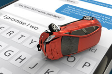 Red car with rollover accident damage lying on cell phone screen with message app and keyboard open